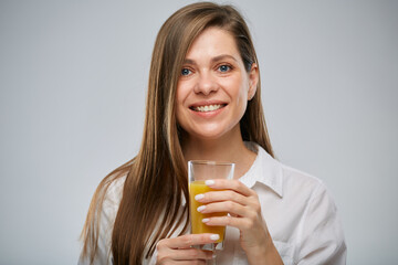 Smiling woman holding orange juice glass. Isolated female advertising portrait.