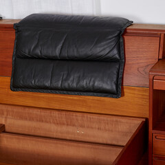 Mid-century modern king-size platform bed. Headrest detail photograph of vintage teak wood bedroom furniture.  