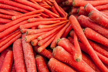 Seamless full frame view of a group of red carrots showcase,  vegetables market in Rajasthan, India