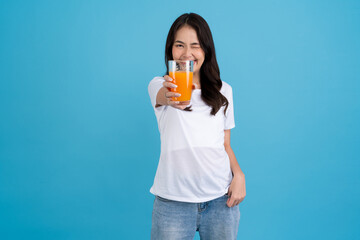 Beautiful woman drinking orange from a glass
