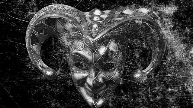 scary jester mask with flickering scratches on a black background