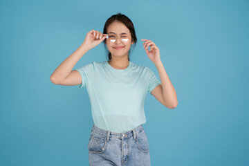 A woman in a blue shirt is smiling in various poses, looking at the camera.