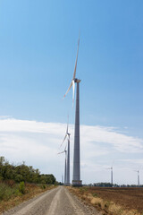 wind turbine in a large field above a blue overcast sky