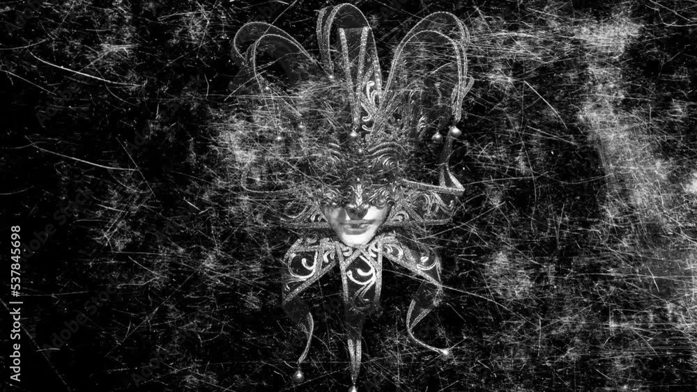 Poster scary jester mask with flickering scratches on a black background