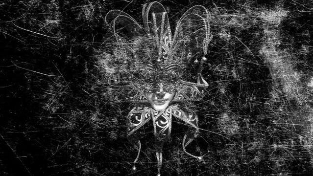 scary jester mask with flickering scratches on a black background
