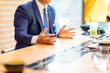 businessman talking while sitting in a chair.