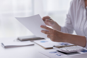 Businessman working at office with documents on his desk, doing planning analyzing the financial report, business plan investment, finance analysis concept	