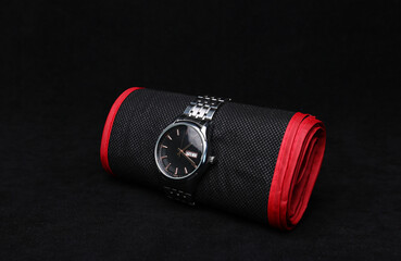 Nice luxury man's wrist watch on dark background. Stainless steel man's wrist watch with black leather strap.