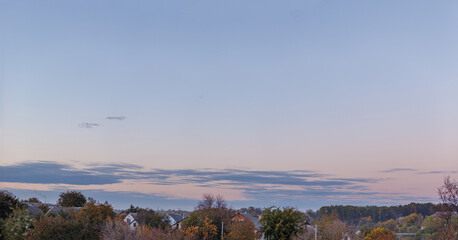 Blue clouds in the sky after sunset, background for design over countryside