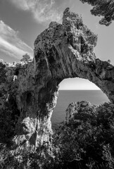 “Arco Naturale“ is a natural limestone arch, a bridge between two pillars of rock located on...