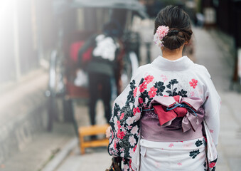  Young women wearing traditional Japanese Kimono with colorful maple trees in autumn is famous in...
