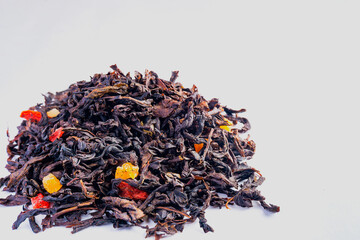 black tea with dried fruit slices on a white background