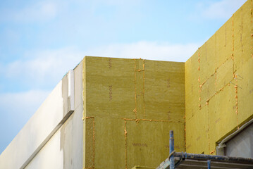 view of construction worker in doing insulation of wall at construction site