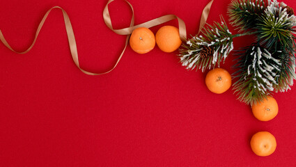 Christmas and New Year background with fir branch, decorations and tangerines. Flat lay, top view.