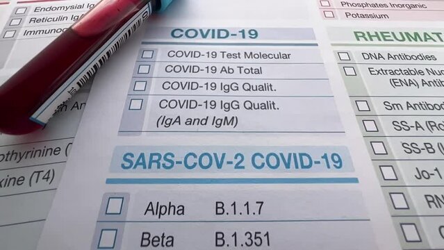Tube with blood from a patient on a test request form for analysis of covid tests. Request form for analysis of blood samples for coronavirus antibody tests