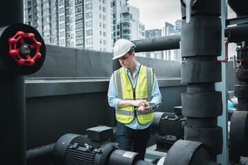 Engineer is checking the cooling system for the air conditioning in a large building or industrial...