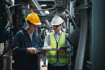 Engineer and team examining the air conditioning cooling system of a huge building or industrial site.