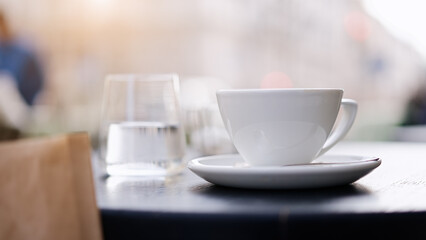 Fototapeta na wymiar Coffee cup on table at street cafe 