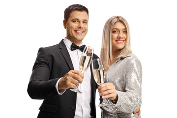 Young man and woman smiling and holding glasses of champagne