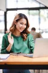 Asian business woman Video call in a teleconference and greet the result..Girl using laptop to video call her friends.