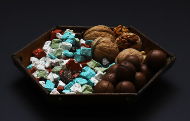 Sweets in the form of sea pebbles in a plate with nuts