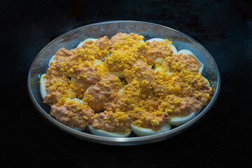 stuffed eggs, with yolk, tuna and pink sauce