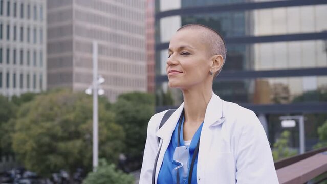 Cinematic footage representation of the daily life of a nurse going to work at the hospital. Young doctor with shaved head and modern look. 
