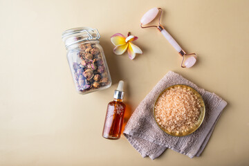 Ayurveda wellness centre  and natura care concept. Top view of  gua sha , natural oil, sea salt scrab and  rose herbs .Flat lay still life