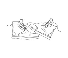 Continuous one line drawing of man work boots. Safety hiking boots line art drawing.