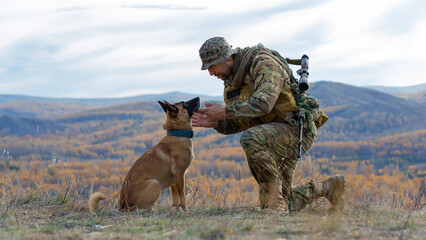 Soldier looks into the eyes of his faithful friend - a dog of the Malinois breed.