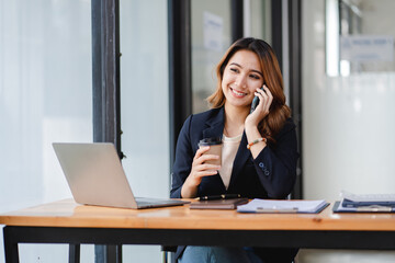 Asian businesswoman chatting on smartphone, auditor, document search, report, analysis, tax, accounting, document, data, contract, agreement at work.