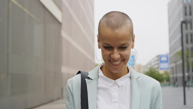 Beautiful modern business woman with shaved head at work during a business journey