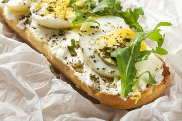 Toast with cream cheese, arugula salad and boiled egg