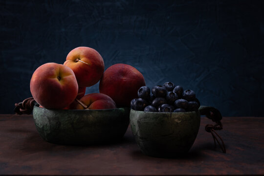 Juicy ripe peaches and blueberries. Still life of berries and fruits. Beautiful photo of berries and fruits.