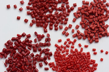 different red plastic granulates für injection moulding - obrazy, fototapety, plakaty