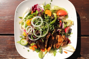 a delicious salad with chicken strips