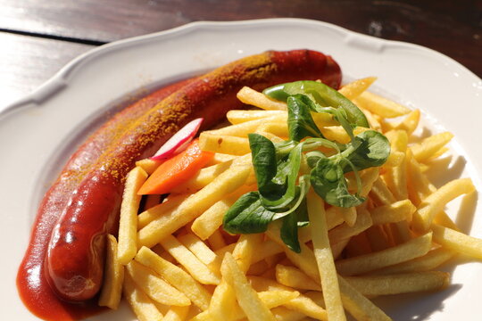 Delicious Sausage With French Fries And Curry Sauce 