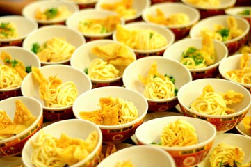 Bowl of noodles with crakers lined up