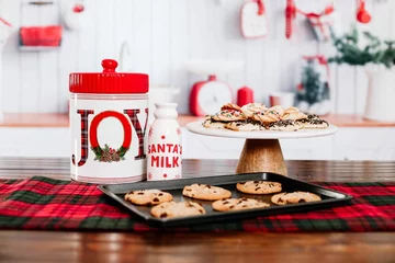 Foto op Canvas Closeup of a Santa's milk bottle with cookies on a wooden table © Tamara Sales/Wirestock Creators