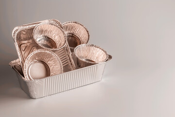 Aluminum foil containers for food preparation. Various shapes of foil eco-friendly boxes. Copy space