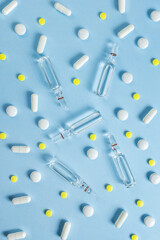 Pharmacy and pharmacology. Medicines, pills and ampoules on a blue background. Beauty vaccines and injections, a concept for a network of pharmacies and medical stores. Vitamins for health