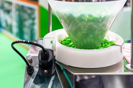 Many Empty Green Capsules In Plastic Hopper For Manufacturing Process Of Automatic Capsule Filling Machine