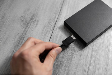 man plugging in a hard drive