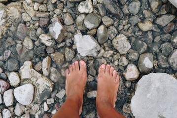 Close up of woman's bare feet in the river