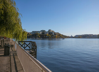Fototapeta na wymiar Piers at the bay Alviks Strand, boat club apartment and office building a sunny a color full autumn day in Stockholm