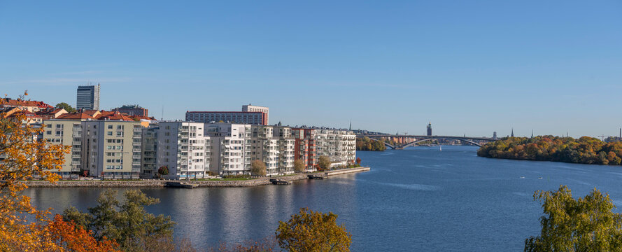 Panorama view, island Essingen, Lux district on the island Lilla Essingen, office, skyscrapers, bridge V&auml;sterbron to the district S&ouml;demalm at a bay in the lake M&auml;laren a sunny a color full autumn day 