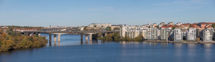 Fototapeta na wymiar Panorama over the Essingen islands and the motorway bridges of Essingeleden and Traneberg, a bay in the lake Mälaren a sunny a color full autumn day in Stockholm