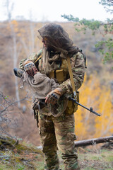 Mercenary military sniper during a sabotage operation behind enemy lines. The concept of modern...