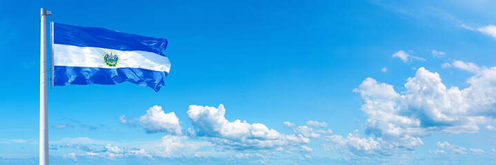 El Salvador flag waving on a blue sky in beautiful clouds - Horizontal banner - obrazy, fototapety, plakaty