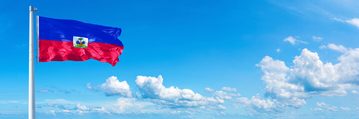 Haiti flag waving on a blue sky in beautiful clouds - Horizontal banner - obrazy, fototapety, plakaty